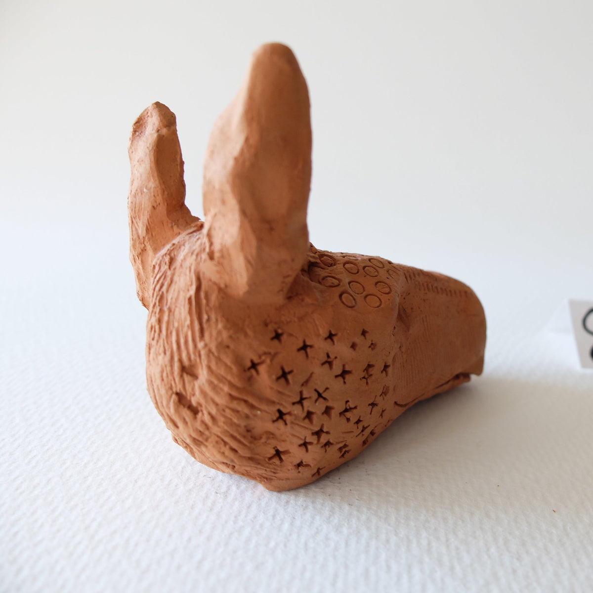 Handcrafted terracotta donkey head sculpture "The Babylonian Donkey (#8)" by Nikolaj Jesper Cyon. Rear perspective view showing the tall sculpted ears and rear head form.