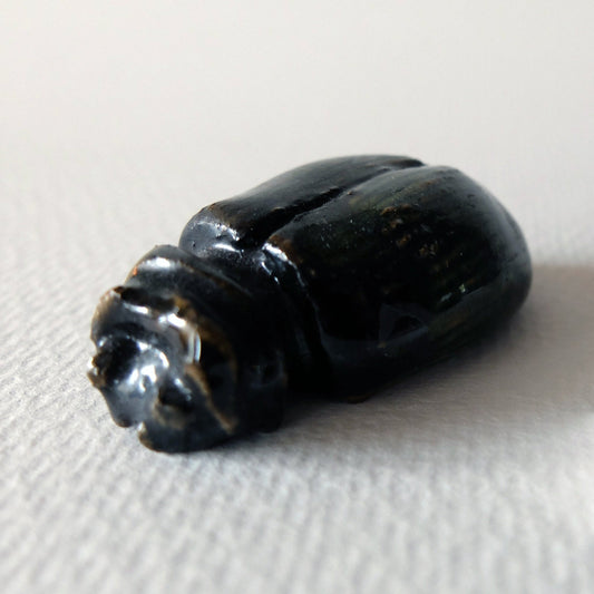 Handcrafted ceramic beetle figurine "The Obsidian Beetle (#4)" in stoneware by Nikolaj Jesper Cyon. Finished with a dark, glossy black and deep brownish glaze over a smooth rounded carapace with sculpted insect anatomy.